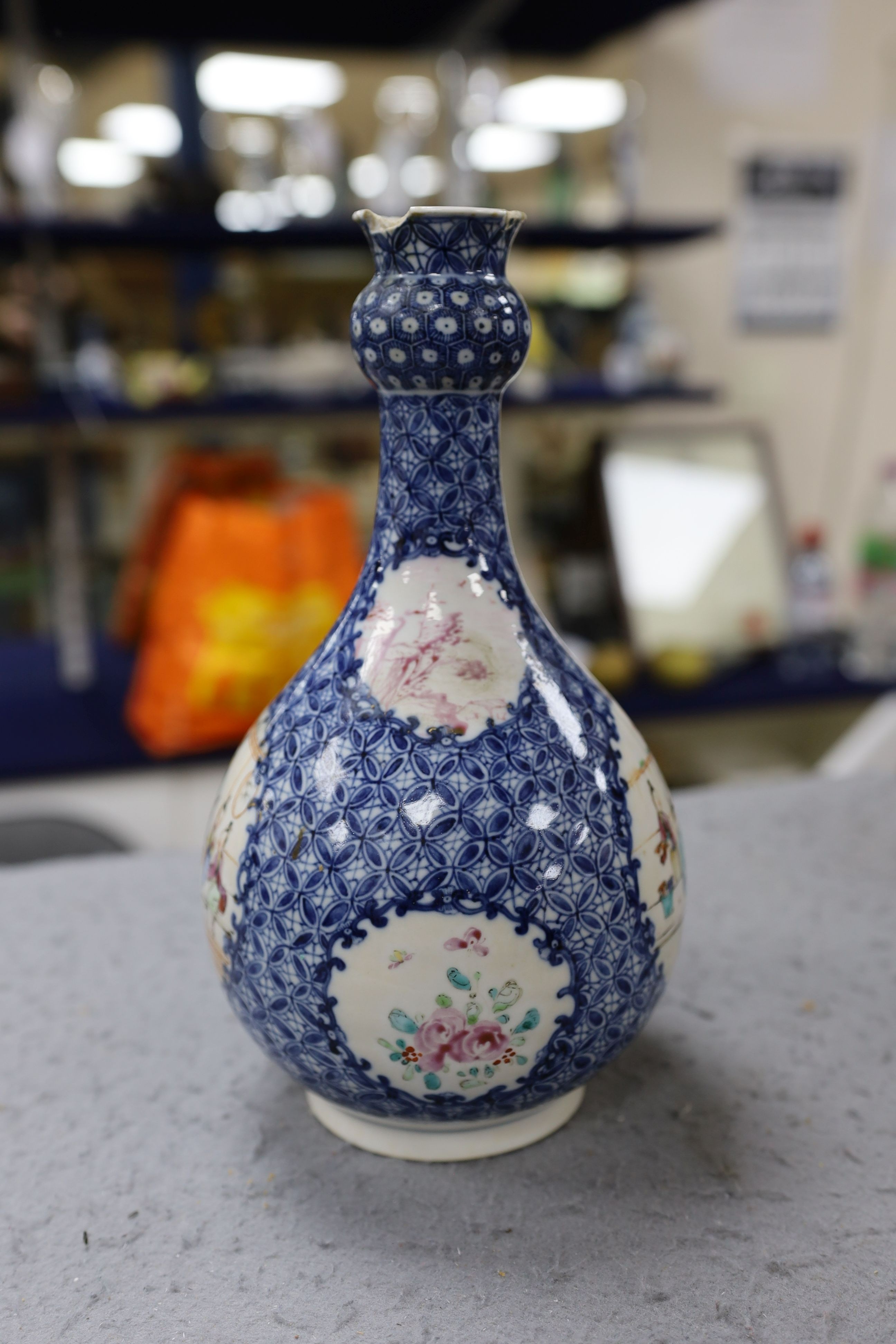 A pair Samson of Paris vases in the Chinese famille verte style and a Chinese Qianlong famille rose garlic neck vase with blue panelling motif, tallest 26cm